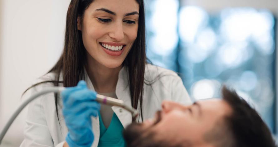 female-dentist-performing-dental-procedure-on-male-2025-04-03-21-15-19-utc