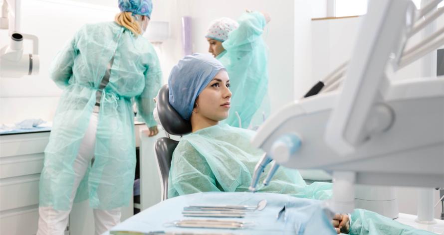 female-patient-and-dentists-preparing-for-procedur-2024-12-04-05-46-09-utc