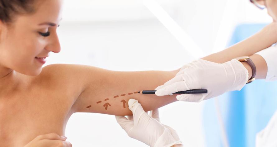 plastic-surgeon-making-marks-on-patient-s-body-2025-01-08-20-42-11-utc